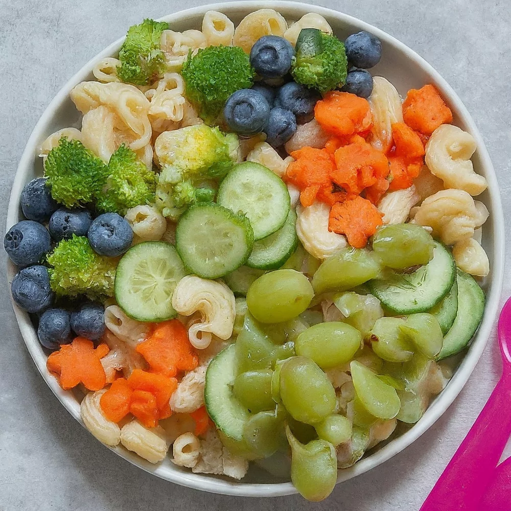 A colorful bowl of pasta salad filled with fresh veggies, perfect for a healthy and fun kids' lunch.