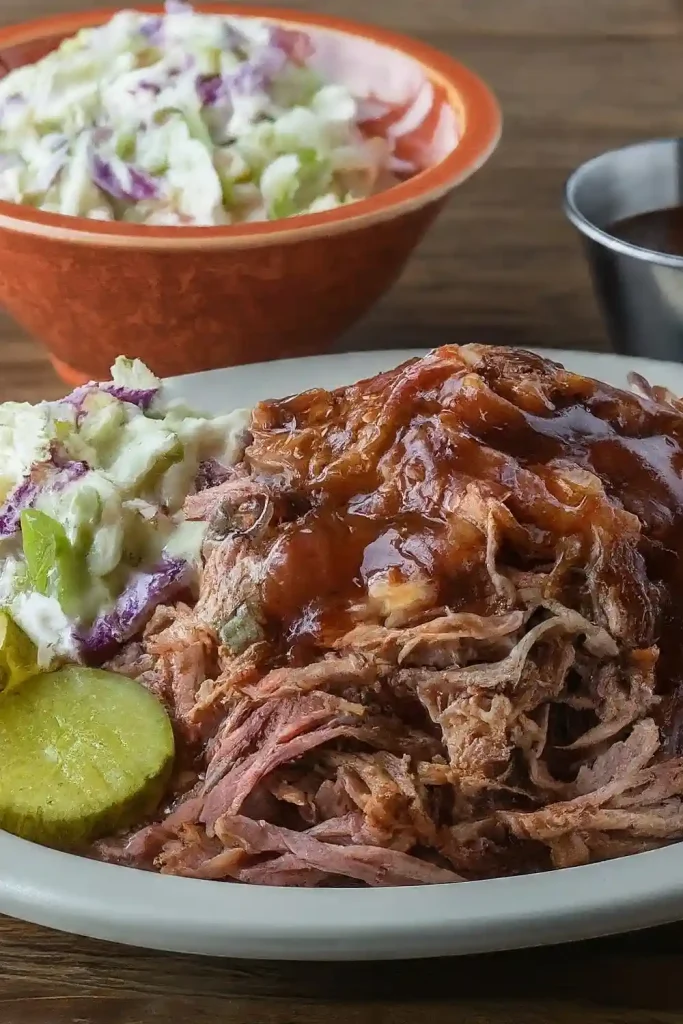 A mouthwatering pile of tender, Traeger-smoked pulled pork or brisket, showcasing the rich smoky flavor and juicy texture.