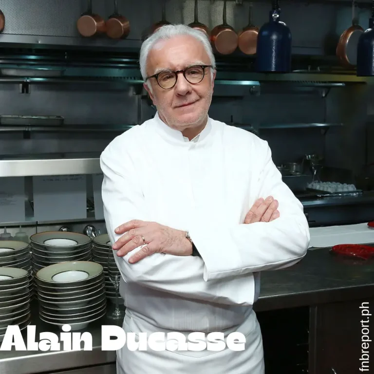 Renowned French chef Alain Ducasse in a professional kitchen, preparing exquisite dishes with precision and expertise.