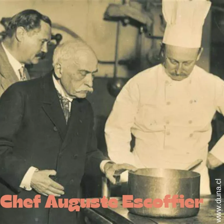 Chef Auguste Escoffier overseeing a cooking demonstration alongside two colleagues, symbolizing his legacy as the father of modern French cuisine.