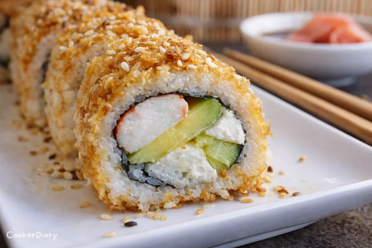 Angled close-up of golden California roll sushi showing crispy exterior and creamy interior.