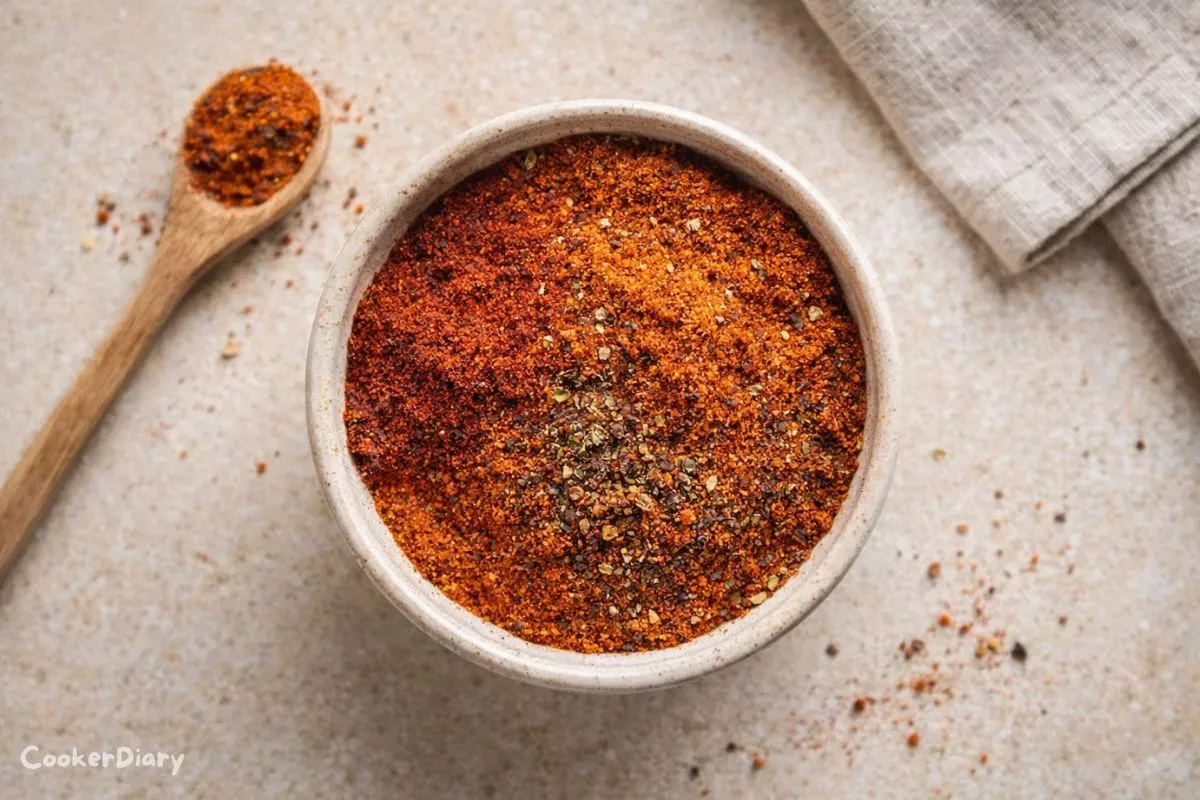 Homemade chicken taco seasoning in a ceramic bowl on a light kitchen counter