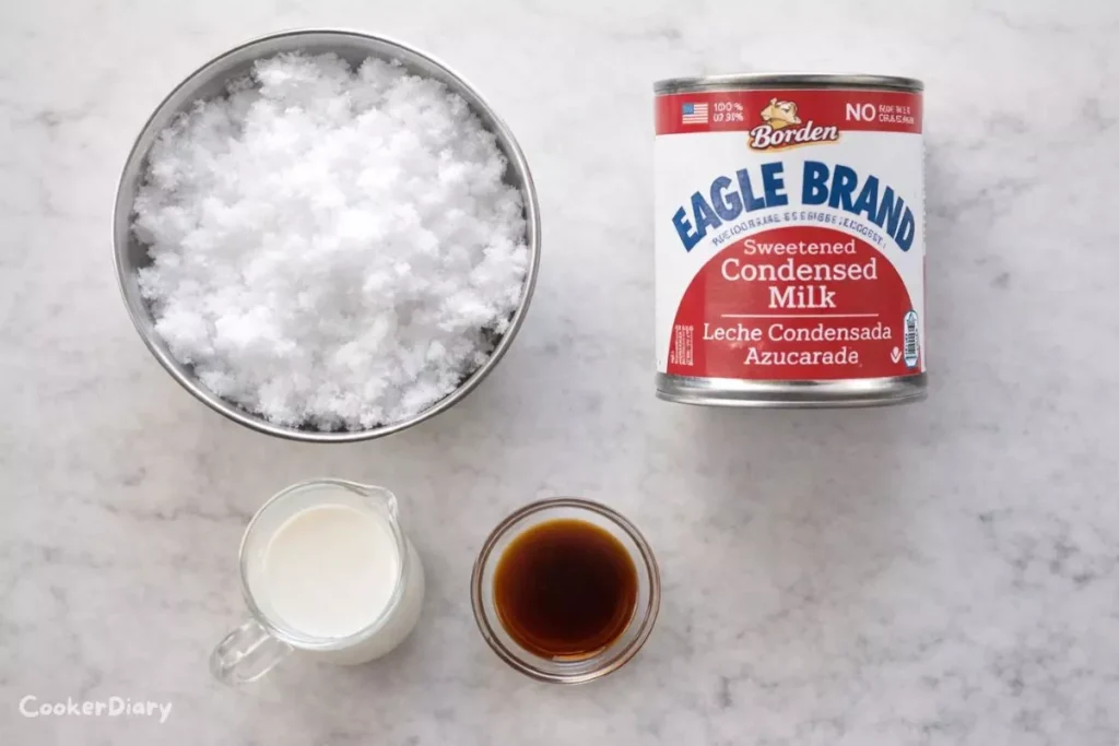 Ingredients for snow ice cream laid out on a marble countertop