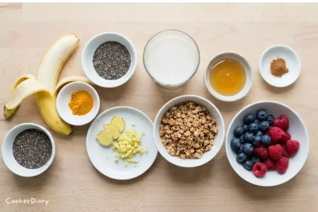 Flat-lay of ingredients for turmeric smoothie bowl on wooden countertop.