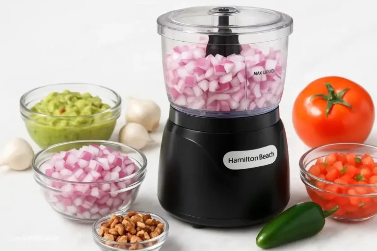 Hamilton Beach Mini Food Processor filled with chopped carrots, onions, and celery on a kitchen countertop