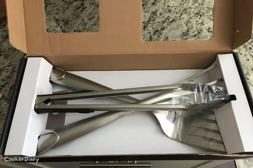 Alpha Grillers Grilling Accessories Set including tongs, spatula, grill brush, and fork in the package