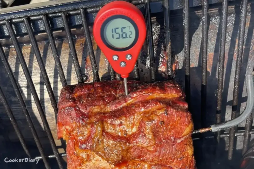 Alpha Grillers instant read digital meat thermometer displaying temperature on a backlit screen
