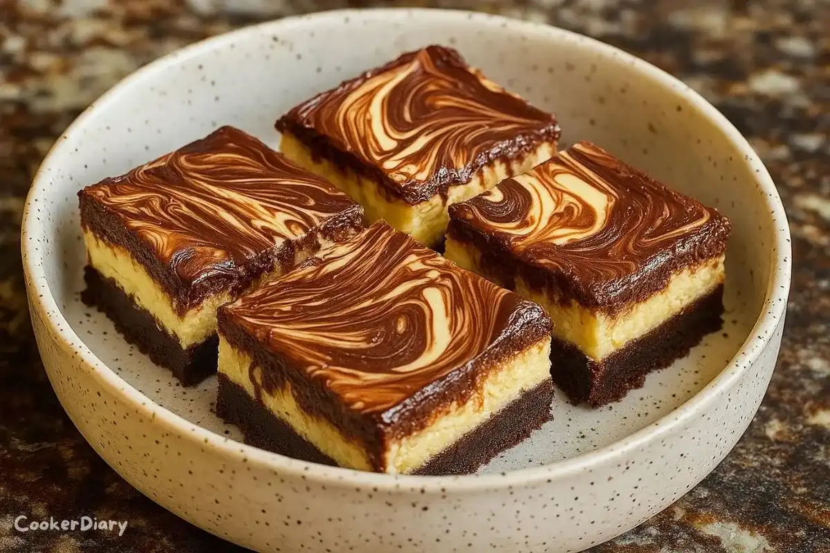 Nutella cheesecake bars with creamy chocolate filling and a biscuit crust, cut into squares on a plate