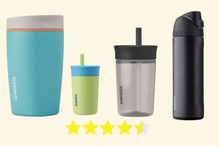 Four colorful Owala travel mugs arranged side by side on a kitchen counter, each with a flip-top lid and sleek design