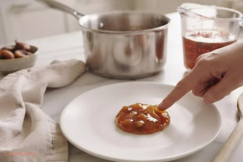 Testing homemade fig jelly for proper consistency