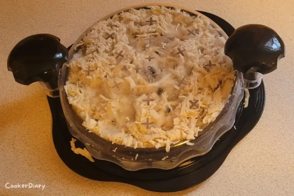 Manual chicken breast grinder machine in elegant black design on a kitchen counter