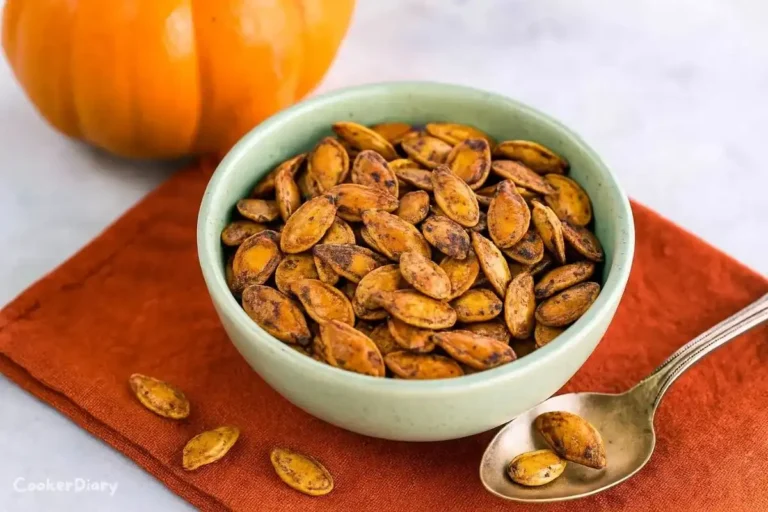 Bowl of golden roasted pumpkin seeds seasoned with spices