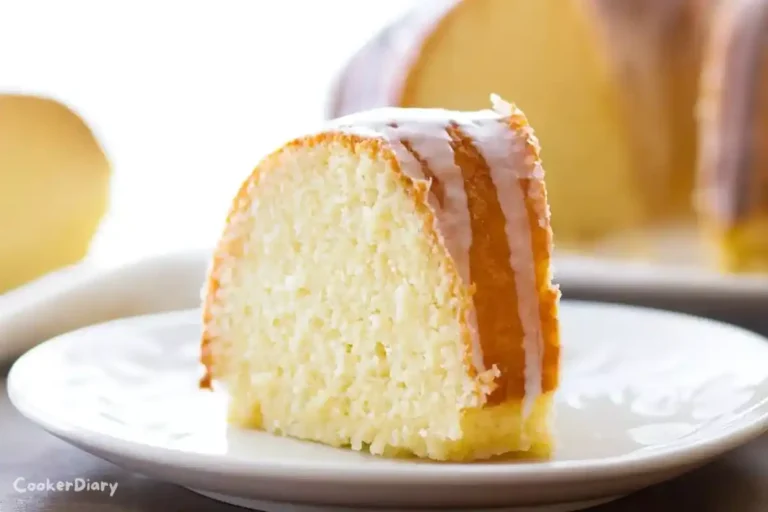 Angled close-up of lemon bundt cake showing glaze and interior crumb.