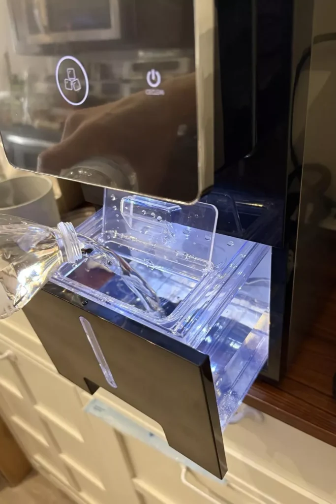 adding water to the ice maker