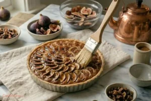 Brushing honey glaze on baked fig tart