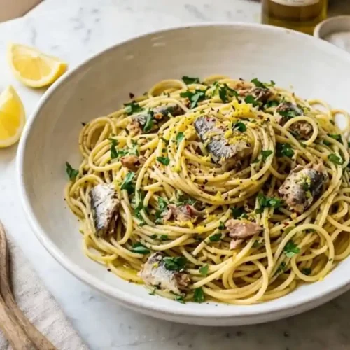 Canned sardine pasta recipe served with lemon and parsley