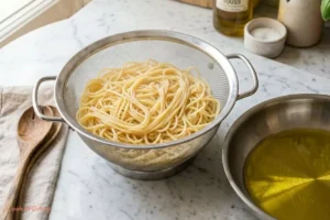 Drained pasta and olive oil heating in skillet